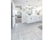 Bright bathroom featuring patterned tile floors, white cabinetry, double vanity and a view into the main bedroom at 4525 Breccia Ln, Lakeland, FL 33811