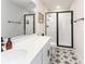 Contemporary bathroom with a glass enclosed shower, modern fixtures, and unique star-patterned tile flooring at 4525 Breccia Ln, Lakeland, FL 33811