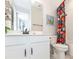 Bathroom featuring a white vanity, black hardware, a floral curtain, and patterned tile floor at 4525 Breccia Ln, Lakeland, FL 33811