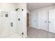 Modern bathroom featuring a tiled shower, patterned floor, and bright lighting at 4525 Breccia Ln, Lakeland, FL 33811