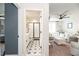 Stylish bathroom with a glass enclosed shower and eye-catching star-patterned tile flooring, next to living room at 4525 Breccia Ln, Lakeland, FL 33811