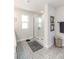 This bathroom features a glass-enclosed shower with white subway tile, patterned tile floors and neutral walls at 4525 Breccia Ln, Lakeland, FL 33811