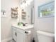 Bright bathroom features a vanity with storage, decorative shelves, and modern fixtures at 4525 Breccia Ln, Lakeland, FL 33811