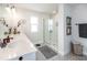 Bathroom featuring a glass-enclosed shower with white subway tile, patterned tile floors and a white countertop sink at 4525 Breccia Ln, Lakeland, FL 33811