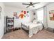 Well-lit bedroom featuring neutral walls, plush carpeting, and decorative sports-themed wall accents at 4525 Breccia Ln, Lakeland, FL 33811