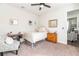 Charming bedroom with a cozy chair, vintage desk, and neutral decor at 4525 Breccia Ln, Lakeland, FL 33811