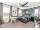 Well-lit bedroom featuring a gray accent wall, desk area, and large windows at 4525 Breccia Ln, Lakeland, FL 33811