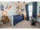 This bedroom features unique wall décor, a comfy blue quilt, and wood crate shelves for a charming and personalized space at 4525 Breccia Ln, Lakeland, FL 33811