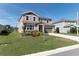 A lovely two-story home features a neatly kept lawn, enhancing its curb appeal, paired with a spacious driveway at 4525 Breccia Ln, Lakeland, FL 33811