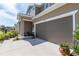 Home exterior showcasing a spacious two car garage, complemented by well-maintained landscaping and a welcoming entrance at 4525 Breccia Ln, Lakeland, FL 33811