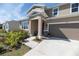 Inviting home exterior showcases manicured landscaping, a welcoming entrance, and a spacious two car driveway at 4525 Breccia Ln, Lakeland, FL 33811