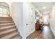 Hallway with stairs, a light wood floor, and an antique piano against the wall at 4525 Breccia Ln, Lakeland, FL 33811