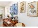 Hallway adorned with decorative artwork, a vintage piano, and an elegant chair, creating a welcoming atmosphere at 4525 Breccia Ln, Lakeland, FL 33811