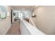 Light-filled hallway overlooking the main level, with a view of the living room at 4525 Breccia Ln, Lakeland, FL 33811