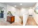 Upstairs hallway features a wooden dresser, white walls, carpet and stairway access at 4525 Breccia Ln, Lakeland, FL 33811