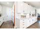 Charming kitchen featuring bright white cabinets, modern hardware, and sleek countertops and wood floors at 4525 Breccia Ln, Lakeland, FL 33811