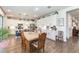 Kitchen and Dining Area featuring an island, stainless steel appliances, seating, and sleek hardwood floors at 4525 Breccia Ln, Lakeland, FL 33811