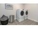 Well-appointed laundry room featuring modern machines and stylish patterned flooring at 4525 Breccia Ln, Lakeland, FL 33811