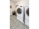 Clean, bright laundry area with modern washer and dryer, ample space, and decorative flooring at 4525 Breccia Ln, Lakeland, FL 33811