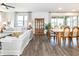 Bright living room featuring hardwood floors, neutral furniture, and an abundance of natural light at 4525 Breccia Ln, Lakeland, FL 33811