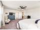 Main bedroom featuring a TV, chairs, neutral decor, and carpeted flooring at 4525 Breccia Ln, Lakeland, FL 33811