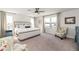 Spacious main bedroom featuring a bed, chairs, side tables, and windows at 4525 Breccia Ln, Lakeland, FL 33811