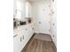 Functional mud room with white cabinets, ample counter space, and convenient access to the entryway at 4525 Breccia Ln, Lakeland, FL 33811