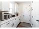 Practical mud room featuring white cabinets, ample counter space, and convenient access to the entryway at 4525 Breccia Ln, Lakeland, FL 33811