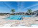 Community pool featuring a large pool, lounge chairs, a splashpad and clear blue sky at 4525 Breccia Ln, Lakeland, FL 33811