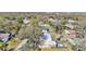 Aerial view of property showcasing the home's location with lush surrounding trees and a fenced backyard at 4620 S Gary Ave, Lakeland, FL 33813