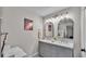 Bathroom featuring double sinks, large mirrors, and stylish gray cabinets at 4620 S Gary Ave, Lakeland, FL 33813