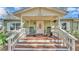 Inviting front porch featuring rocking chairs and decorative floral arrangement on door at 4620 S Gary Ave, Lakeland, FL 33813