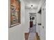 Hallway with artwork leading into bedroom with washer/dryer on right at 4620 S Gary Ave, Lakeland, FL 33813