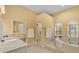 Bright bathroom with a shower, jacuzzi tub, vanity, and windows providing natural light at 4769 Highlands Place Cir, Lakeland, FL 33813