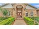 Inviting front entrance with brick walkway leading to elegant double doors at 4769 Highlands Place Cir, Lakeland, FL 33813