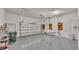 Spacious two car garage with ample storage and bright overhead lighting at 4769 Highlands Place Cir, Lakeland, FL 33813