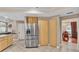 Kitchen with stainless steel refrigerator and wooden cabinets providing ample storage space at 4769 Highlands Place Cir, Lakeland, FL 33813