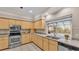 Kitchen featuring stainless steel appliances, generous counter space, and a view of the backyard pool at 4769 Highlands Place Cir, Lakeland, FL 33813