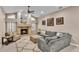 Cozy living room featuring a fireplace, high ceilings, neutral paint, and comfortable gray sofa at 4769 Highlands Place Cir, Lakeland, FL 33813