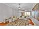 Bright living room featuring hardwood floors, a patterned rug, and modern lighting at 4769 Highlands Place Cir, Lakeland, FL 33813