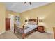 Comfortable main bedroom featuring a four poster bed, carpeted floor, and built in shelving at 4769 Highlands Place Cir, Lakeland, FL 33813