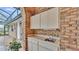 Outdoor kitchen space featuring a sink, counter space and cabinet storage at 4769 Highlands Place Cir, Lakeland, FL 33813