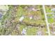 Aerial view of a home with a large yard, storage shed, and a nearby creek in a rural setting at 5062 1St Nw St, Lakeland, FL 33810