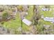 Overhead view of a property with a large metal storage shed on a well-maintained, grassy lot with mature trees at 5062 1St Nw St, Lakeland, FL 33810