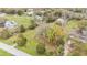 Scenic aerial view of a home with mature trees and a sprawling green lawn on a sunny day at 5062 1St Nw St, Lakeland, FL 33810