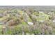 Aerial view of a home with a large storage shed, surrounded by lush greenery and natural landscape at 5062 1St Nw St, Lakeland, FL 33810