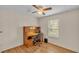 Bedroom featuring a built-in desk, ceiling fan, and a window offering natural light at 5062 1St Nw St, Lakeland, FL 33810