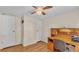 Bedroom featuring built-in desk, ceiling fan, and closet for storage at 5062 1St Nw St, Lakeland, FL 33810