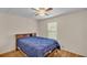 Bedroom featuring a large bed, ceiling fan, and a window offering natural light at 5062 1St Nw St, Lakeland, FL 33810