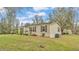 Single-story home featuring a manicured lawn and neutral color palette at 5062 1St Nw St, Lakeland, FL 33810